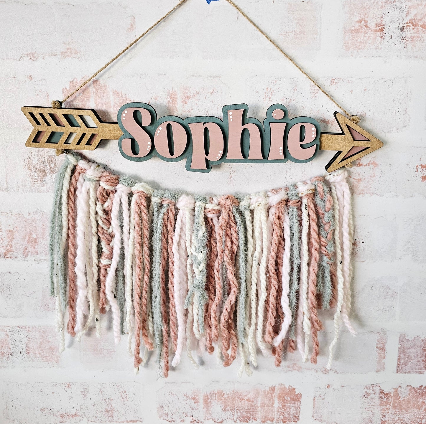 Hanging arrow with yarn wall decor